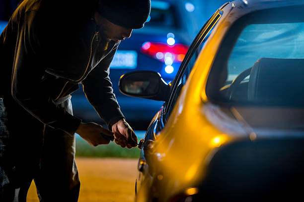 A photo depicting a car thief stealing a vehicle, illustrating the serious crime of grand theft auto as defined under California Penal Code Section 487(d)(1). This crime carries severe penalties, including imprisonment, hefty fines, and lasting legal consequences. Learn more about California's grand theft auto laws, penalties, and legal defenses in this comprehensive guide.